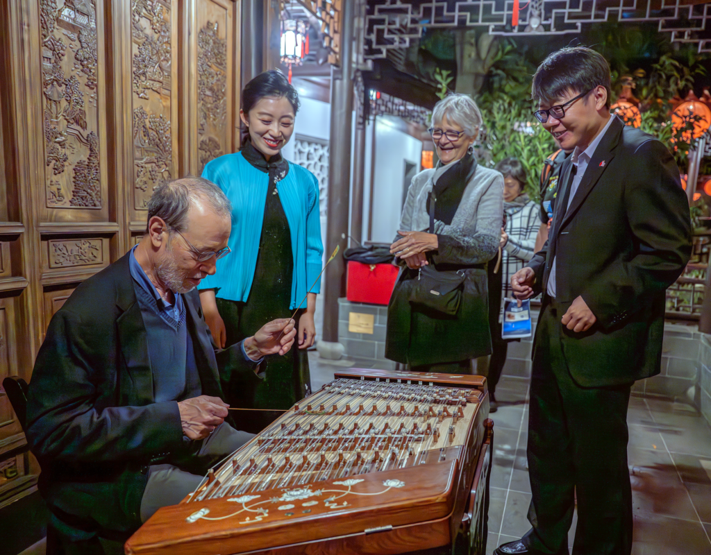 演出結束後的互動環節，州參議員德蒙布羅（左）對中國傳統樂器揚琴產生了濃厚的興趣